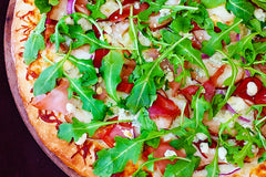 Prosciutto arugula gorgonzola pizza